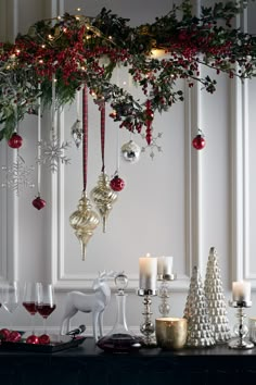 a table topped with christmas decorations and candles