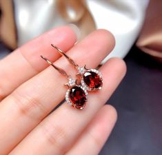 Welcome to Elegant Art Jewelry!  Material: 925 Sterling Silver Stone: Natural Garnet Stone Size: 7mmX9mm Origin: Mozambia Side Stone: Zircon Personalization: 9K/14K/24K/GOLD/SILVER/PLATINUM/ROSE-GOLD/WHITE GOLD. (Contact me)  Garnet Earrings, Garnet Cuff Earrings, Gold Earrings, Gold Stud Earrings, 14k Gold Earrings, 14k Gold Earrings, Round Cut Earrings, Round Cut Stone Earrings, Round Cut Studs Earrings, Garnet Drop Earrings, Garnet Studs Earrings, Garnet Studs, Garnet Earrings, Garnet Dangle Garnet Drop Earrings, All Crystals, Engagement Earrings, Luxury Earrings, Earrings Round, Garnet Jewelry, Red Gemstones, Garnet Earrings, Studs Earrings