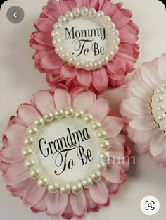 three pink and white flowers with the words grandma to be written on them, sitting next to each other