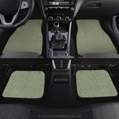 the interior of a car with green floor mats