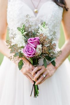 a woman holding a bouquet of flowers in her hands