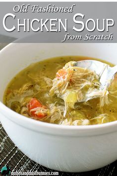 a white bowl filled with chicken soup on top of a table