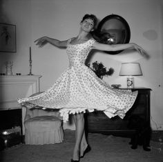 a woman in a dress is dancing on the floor