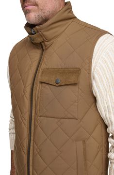 Water-resistant construction and a quilted body offer exceptional comfort in a rugged, versatile vest. 27" length Stand collar Water-resistant 100% polyester Machine wash, tumble dry Imported Sleeveless Outdoor Outerwear With Padded Collar, Sleeveless Outerwear With Padded Collar For Outdoor, Sleeveless Brown Outerwear For Outdoor, Quilted Nylon Vest For Cold Weather, Quilted Nylon Vest For Fall, Quilted Winter Vest For Outdoor, Quilted Winter Outdoor Vest, Outdoor Nylon Vest With Padded Collar, Nylon Vest With Padded Collar For Outdoor