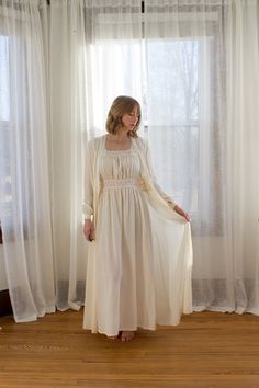 1930's semi-sheer silk chiffon peignoir set. The nightgown features a gathered bodice with lace straps, inset lace detailing, side snap closure and flattering A-line skirt. The robe/dressing gown has full sleeves that close with covered buttons, matching lace, and covered button closure in the front.  *Condition* Very good vintage condition. The only real "flaw" is that you can see the brand label through the chiffon on the front of the robe. Cleaned and ready to wear! Measurements- Gown- Bust 3 Button Up Nightgown, Vintage Peignoir Sets, Vintage Dressing Gown, Wedding Nightgown, Bridal Nightgown, Gathered Bodice, Peignoir Sets, Silk Nightgown, Side Snap