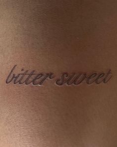 a woman's back with the word bitter sweet written in cursive font