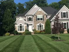 a large house with lots of windows in the front yard