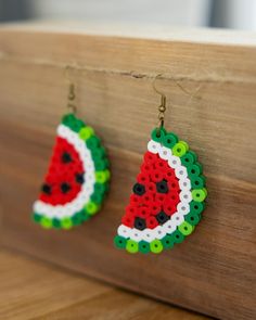 the earrings are made out of legos and have watermelon slices on them