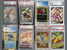 many pokemon cards are on display in plastic cases