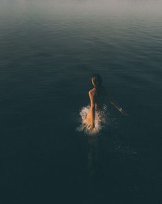 a man riding on top of a surfboard in the ocean