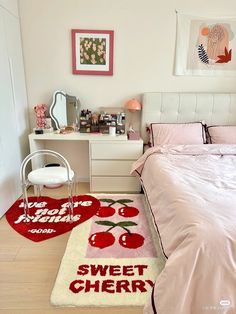 a bedroom decorated in pink and white with cherry rugs