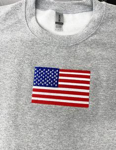 The American Flag Embroidered Sweatshirt is a classic and timeless piece that showcases the iconic American flag design. It's the perfect sweatshirt for celebrating the 4th of July and Independence Day, allowing you to display your patriotism in style. This trendy crewneck sweatshirt is not only fashionable but also serves as a symbol of pride and love for the United States. It makes a great patriotic gift for anyone who wants to express their American spirit. Whether you're attending a July 4th Cotton Crew Neck Sweatshirt With Flag Print, Patriotic Crew Neck Sweatshirt For Independence Day, Brother Luminaire, Trendy Crewneck Sweatshirt, Trendy Crewneck, American Flag Design, Sweatshirt Trendy, American Spirit, Patriotic Gifts