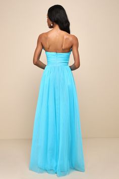 the back of a woman in a blue dress