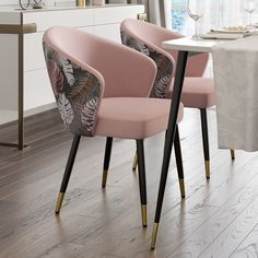 three pink chairs sitting next to each other on top of a hard wood floored floor