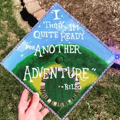 someone is holding up a graduation cap that says i think i'm quite ready for another adventure