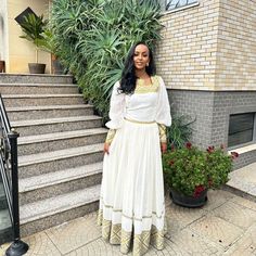 This simple Habesha dress, also known as a Habesha Kemis, embodies the elegance of Ethiopian traditional dress with a modern twist. Featuring a light color palette, this dress combines contemporary design with timeless cultural elements, making it a perfect choice for both everyday wear and special occasions. Material Cotton Menen Thread Estimated delivery : 2 weeks to 4 weeks Contact WhatsApp +1(304)-306-2784Email: contact@ethiopian.store Off White Festive Dresses With Traditional Drape, Off White Fitted Dress With Traditional Drape, White Maxi Dress With Traditional Drape For Eid, Traditional Beige Floor-length Dress, White Long Dress For Eid, White Traditional Drape Maxi Dress For Eid, Traditional Off White Maxi Dress, Off White Dress For Eid With Traditional Drape, Off-white Dress For Eid With Traditional Drape