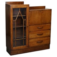 an old fashioned wooden cabinet with glass doors