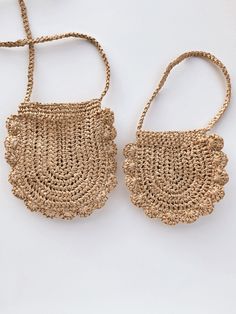 two straw purses on a white surface