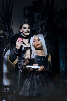 two women dressed up as witches holding plates