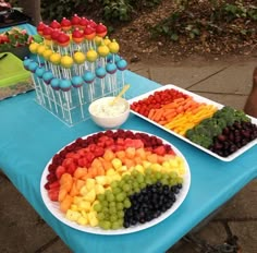 a table topped with lots of different types of fruits and veggies on plates