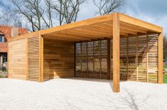 a large wooden structure sitting on top of a gravel field