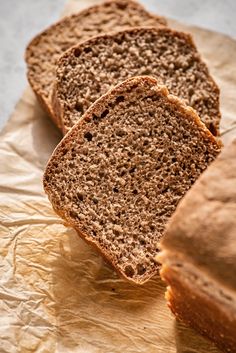 three slices of bread sitting on top of wax paper