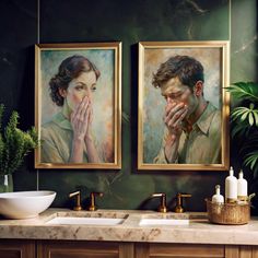 two paintings on the wall above a sink in a green bathroom with gold faucets