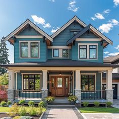 a large blue house with two story windows