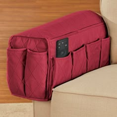 the back of a couch with a remote control in it's pocket on top