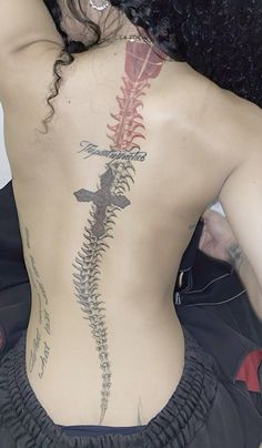 the back of a woman with tattoos on her body