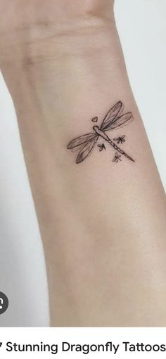 a small dragonfly tattoo on the wrist