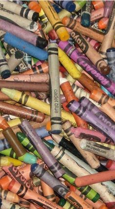 many different colored crayons are grouped together