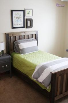 a bedroom with a bed, nightstand and pictures on the wall