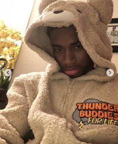 a young man wearing a teddy bear hoodie with the word thunder buddies for life on it