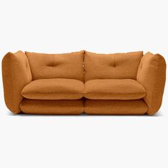 an orange couch sitting on top of a white floor