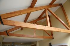 an unfinished ceiling in a kitchen with wood beams