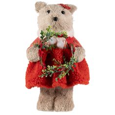 a teddy bear holding a christmas wreath with greenery on it's chest and wearing a red sweater