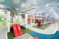 the children's playroom is brightly decorated with colorful murals and slides to sliders