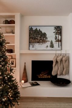 a decorated christmas tree in front of a fireplace