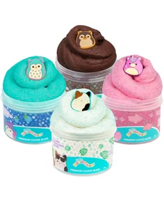 three cupcakes in plastic containers with animals on the top and one has an owl