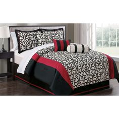 a black and white bed with red accents