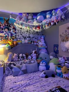 a bed with lots of stuffed animals on top of it in a room filled with toys