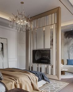 a bedroom with a bed, chandelier and television