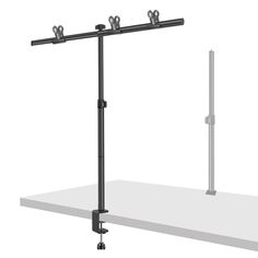 a black and white photo of a shelf with two poles on it, one pole is attached to the wall