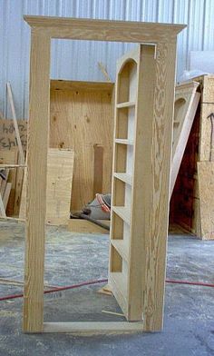 an unfinished bookcase in the process of being built with plywood and other materials