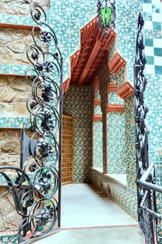 an ornate iron gate in front of a tiled wall