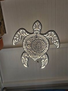 an intricately designed sea turtle is mounted to the ceiling