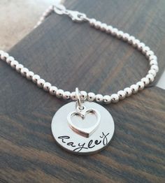 Silver Personalized Heart Bracelet, Everyday Silver Charm Bracelet With Custom Name, Personalized Heart Bracelet For Everyday, Personalized Charm Bracelet For Everyday And Mother's Day, Customizable Name Bracelet For Everyday, Stamped Bracelets As Personalized Gift For Mother's Day, Stamped Bracelets For Mother's Day Personalized Gift, Hand Stamped Sterling Silver Bracelets For Mother's Day, Adjustable Hand Stamped Charm Bracelet For Everyday