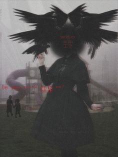 a woman with black wings on her head standing in front of a playground and people