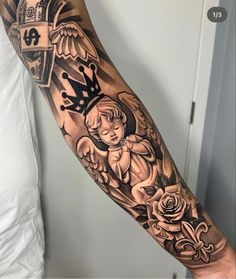 a man's arm with an angel and roses tattoo design on the left forearm